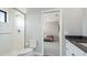 Bright bathroom showcasing a glass-enclosed shower and view into the connecting bedroom at 10165 Canaveral Cir, Sarasota, FL 34241
