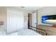 Bright bedroom showcasing the neutral interior, hardwood floors, and closet at 10165 Canaveral Cir, Sarasota, FL 34241