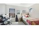 Well-lit bedroom with a desk and guitar, offering a comfortable and functional space at 10165 Canaveral Cir, Sarasota, FL 34241