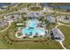 An aerial shot of the community pool with ample seating, well-kept landscaping, and Gathering-friendly water features at 10165 Canaveral Cir, Sarasota, FL 34241