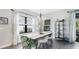 The dining area features hardwood floors, lots of light, and modern decor at 10165 Canaveral Cir, Sarasota, FL 34241
