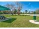 Well-maintained dog park with a bench, waste station, and lush green grass, ideal for pets at 10165 Canaveral Cir, Sarasota, FL 34241