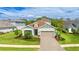 Inviting single-Gathering home boasts a well-manicured lawn, paver driveway and lush landscaping at 10165 Canaveral Cir, Sarasota, FL 34241