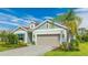 Beautiful single-Gathering home with a two-car garage, paver driveway, and manicured lawn at 10165 Canaveral Cir, Sarasota, FL 34241