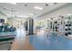 Modern fitness center with a variety of cardio and weight training equipment and mirror at 10165 Canaveral Cir, Sarasota, FL 34241