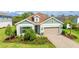 Charming home featuring a manicured front lawn, beautiful landscaping, paved driveway, and a two-car garage at 10165 Canaveral Cir, Sarasota, FL 34241