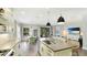 Bright, open kitchen with island seating that flows into the living and dining areas at 10165 Canaveral Cir, Sarasota, FL 34241