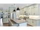 Modern kitchen featuring custom cabinets, stainless steel appliances, and a large center island with seating at 10165 Canaveral Cir, Sarasota, FL 34241