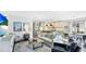 Open-concept living room with stylish decor and access to the kitchen and dining area at 10165 Canaveral Cir, Sarasota, FL 34241