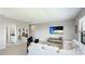 Cozy living room featuring comfortable seating, a wall-mounted TV, and decorative guitars on the wall at 10165 Canaveral Cir, Sarasota, FL 34241