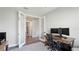 Bright home office featuring double doors and view of the hallway, a wooden desk and an office chair at 10165 Canaveral Cir, Sarasota, FL 34241
