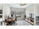 Bright home office with a wooden desk, an office chair, a ceiling fan and a large window at 10165 Canaveral Cir, Sarasota, FL 34241