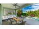 Inviting outdoor patio with comfortable seating, a dining table, and views of the lush backyard and pool at 10165 Canaveral Cir, Sarasota, FL 34241
