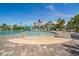 Resort-style zero entry pool with a splash fountain, sun loungers, and cabanas, perfect for relaxation at 10165 Canaveral Cir, Sarasota, FL 34241