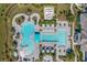 Aerial view of a resort-style pool and lounge area, including lush landscaping and plenty of seating at 10165 Canaveral Cir, Sarasota, FL 34241