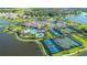 Aerial view of community amenities including the pool, tennis courts, and clubhouse at 10230 Highland Park Pl, Palmetto, FL 34221