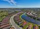 Aerial view of a neighborhood with well-maintained houses, serene lakes, and lush green spaces at 10230 Highland Park Pl, Palmetto, FL 34221