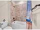 Bathroom with shower and tub featuring decorative blue shower curtain at 10230 Highland Park Pl, Palmetto, FL 34221