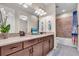 Bathroom with double vanity, neutral countertops, and decorative elements at 10230 Highland Park Pl, Palmetto, FL 34221