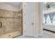 Tiled shower with glass door and shower head at 10230 Highland Park Pl, Palmetto, FL 34221