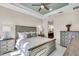 Neutral bedroom with large bed, tray ceiling with fan and lots of natural light at 10230 Highland Park Pl, Palmetto, FL 34221