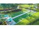 Overhead shot of bocce ball court with sun umbrellas and lush landscaping and nearby walking path at 10230 Highland Park Pl, Palmetto, FL 34221