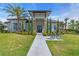 Beautiful clubhouse with a manicured lawn, swaying palms, and convenient bicycle parking at 10230 Highland Park Pl, Palmetto, FL 34221
