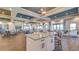 Spacious clubhouse area features a dining and gathering area, with luxurious tile flooring and stylish decor at 10230 Highland Park Pl, Palmetto, FL 34221