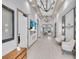 Bright hallway features modern lighting, television, and access to a dining area with a scenic view at 10230 Highland Park Pl, Palmetto, FL 34221