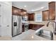 Kitchen featuring stainless steel appliances, granite counters, and dark wood cabinets at 10230 Highland Park Pl, Palmetto, FL 34221