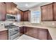 Kitchen featuring stainless steel appliances, tile backsplash, and ample cabinet space at 10230 Highland Park Pl, Palmetto, FL 34221