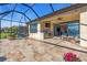 Enjoy outdoor living in this screened lanai, complete with outdoor kitchen, seating, and tranquil lake views at 10230 Highland Park Pl, Palmetto, FL 34221