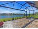 Relaxing screened lanai overlooking a serene lake with comfortable seating and scenic views at 10230 Highland Park Pl, Palmetto, FL 34221