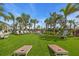 Expansive lawn area with cornhole boards and seating, perfect for outdoor activities and relaxation at 10230 Highland Park Pl, Palmetto, FL 34221