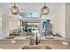 Kitchen breakfast bar overlooking open concept living room with water views at 10230 Highland Park Pl, Palmetto, FL 34221