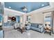 Open concept living room featuring a blue ceiling, tile floors, and modern furnishings at 10230 Highland Park Pl, Palmetto, FL 34221
