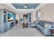 Open-concept living area connecting the living room to the kitchen, with lake views, comfortable seating, and modern decor at 10230 Highland Park Pl, Palmetto, FL 34221