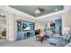 Living room with large entertainment center and open access to the kitchen at 10230 Highland Park Pl, Palmetto, FL 34221