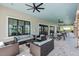 Relaxing covered outdoor seating area equipped with plush sofas and dining tables at 10230 Highland Park Pl, Palmetto, FL 34221