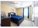 Bedroom featuring carpet, a dark wood bed frame, blue accents, and a window with natural light at 10527 Falling Leaf Ct, Parrish, FL 34219