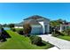 Beautiful single-Gathering home boasts lush landscaping, a paver driveway, and an attached two-car garage at 10527 Falling Leaf Ct, Parrish, FL 34219