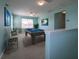 Bright game room features a pool table, seating, and a window for natural light at 10527 Falling Leaf Ct, Parrish, FL 34219