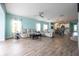 An open-concept living room with tile floors, comfortable seating, and access to the kitchen and dining area for easy entertaining at 10527 Falling Leaf Ct, Parrish, FL 34219