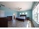 Spacious main bedroom with light blue walls, ceiling fan, carpet flooring, and lots of natural light at 10527 Falling Leaf Ct, Parrish, FL 34219