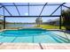 Take a dip in the pool and enjoy the lake view from the screened patio at 10527 Falling Leaf Ct, Parrish, FL 34219