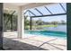 Enjoy the screened in pool and lanai overlooking a serene lake at 10527 Falling Leaf Ct, Parrish, FL 34219