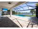 Backyard with a screened in pool with views of the lake at 10527 Falling Leaf Ct, Parrish, FL 34219