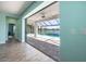 Beautiful view of pool and lake through sliding glass door and screened in patio at 10527 Falling Leaf Ct, Parrish, FL 34219