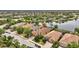 Aerial view of the community showcasing lake views, mature trees, and well-maintained landscaping around the single-Gathering homes at 12711 Del Corso Loop, Bradenton, FL 34211