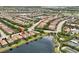 An aerial view of the home emphasizing its prime lakeside location and proximity to nearby community amenities and lush surroundings at 12711 Del Corso Loop, Bradenton, FL 34211